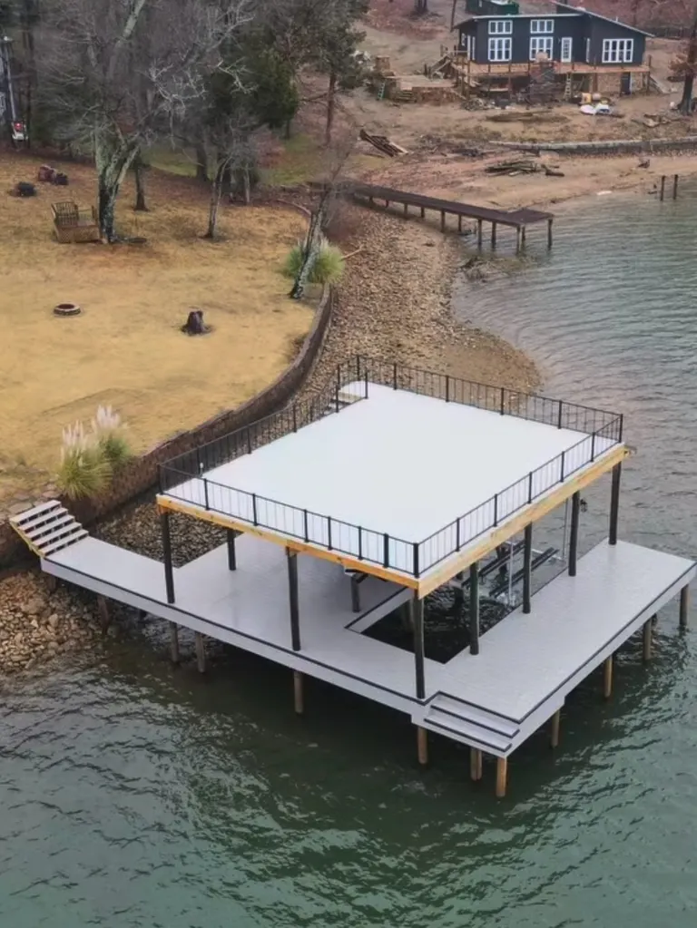 Aerial view of a two-story dock with a railed upper deck along the shoreline